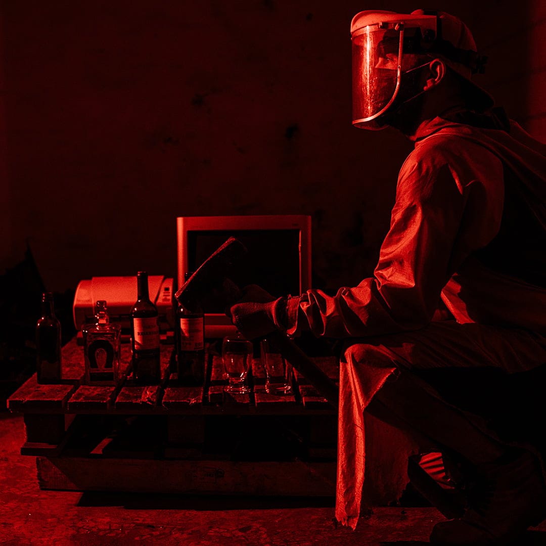 Person kneeling in red rage room