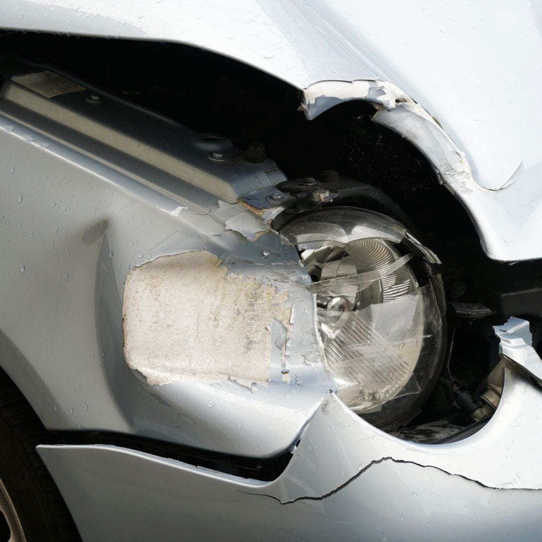 A car with a smashed headlight