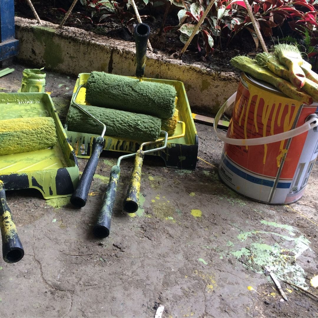 paint rollers and brush with bucket
