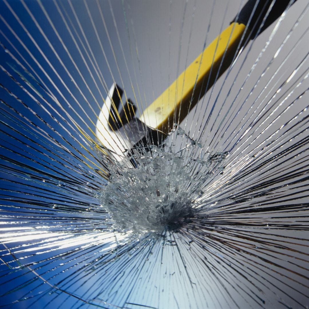 smashing glass with a hammer