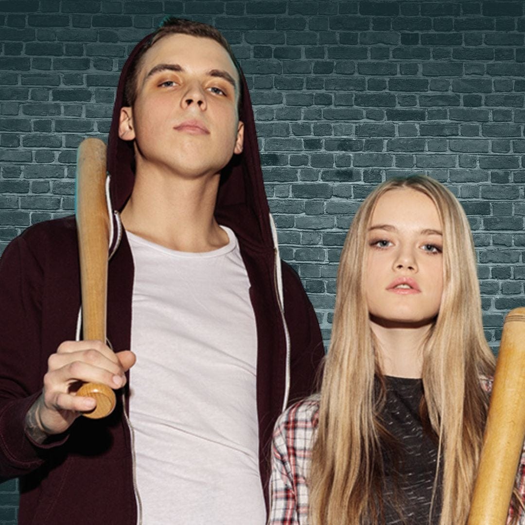 a guy and girl holding bats together