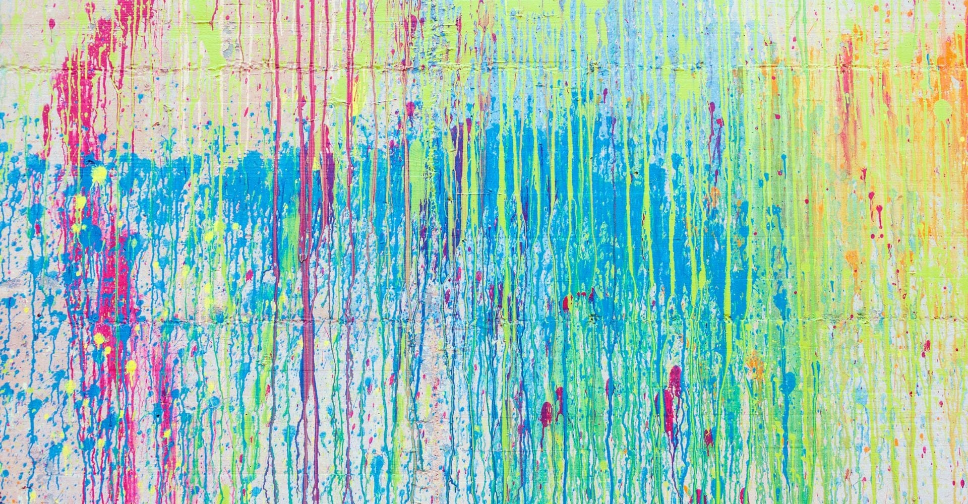 colorful paint splattered all over a white wall